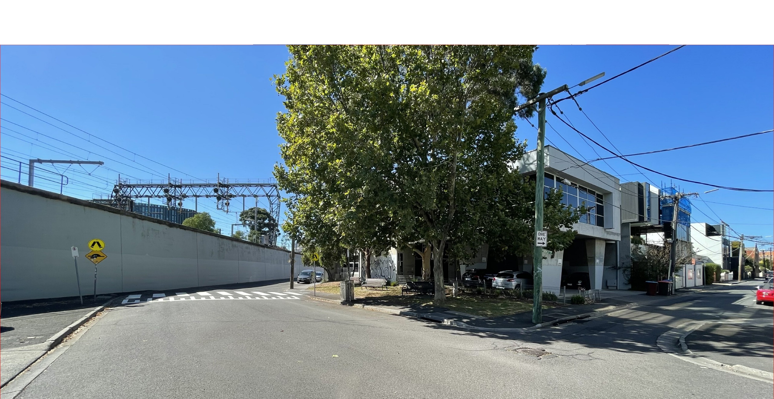 Current site: Photo of small urban pocket park overgrown with shrubs