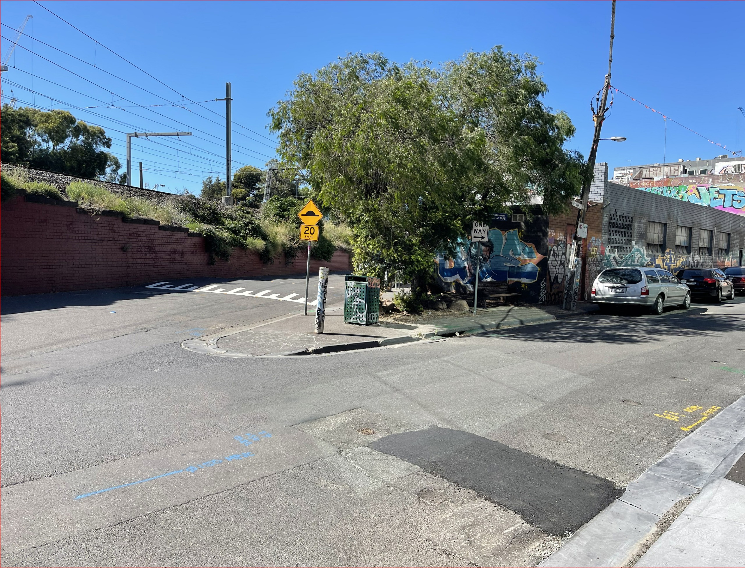 Existing space: Photo of small urban pocket park overgrown with shrubs